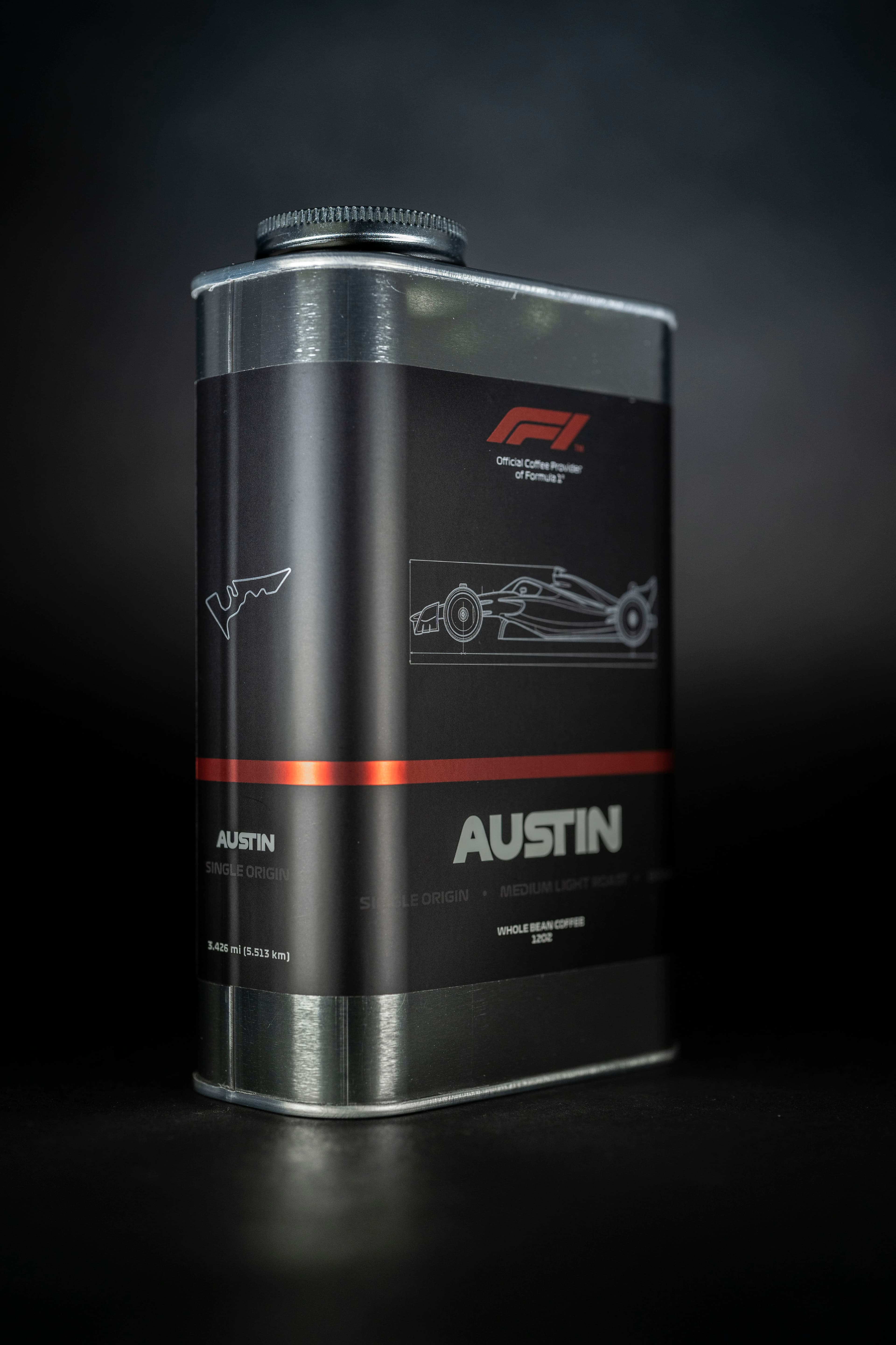 F1 coffee can product photography on dark background